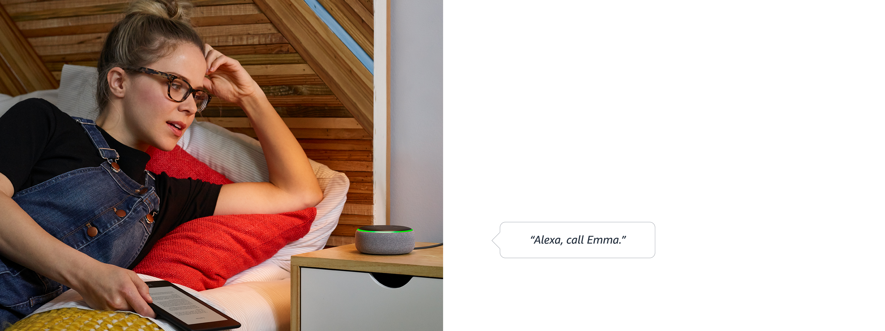  A female speaking “Alexa, call Emma” to an Echo Dot placed on a night stand while lying in the bed with a kindle reader in her hand 